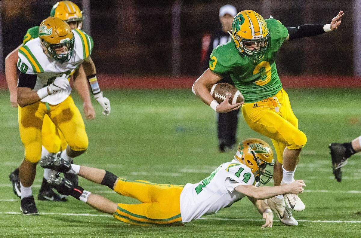 Lynden’s Brock Heppner (3) slips through the hands of Tumwater linebacker Jack Prentice during the second quarter of the 2A state playoffs on Saturday, Nov. 17. The Lions face Fife in the state quarterfinals Saturday.