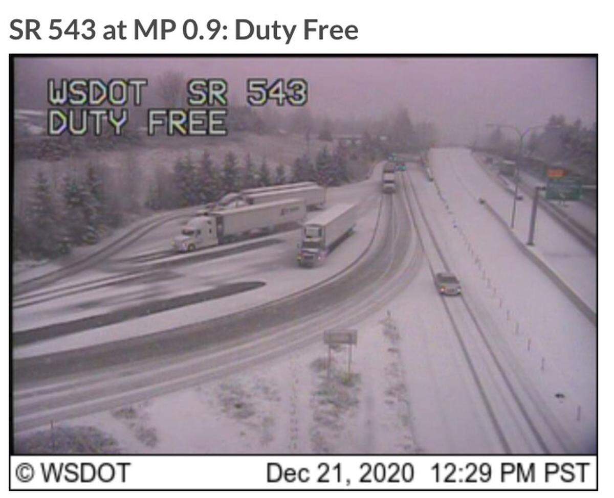 A Washington state Department of Transportation camera shows snow covering the ground Monday, Dec. 21, on Pacific Highway east of Blaine, at a crossing for commercial trucks on the U.S.-Canada border.