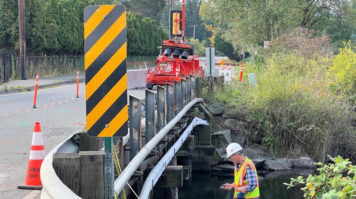 A city employee works under the Electric Avenue bridge over Lake Whatcom on Wednesday. Pilings were strengthened to support the bridge so it could opened to two lanes of traffic.