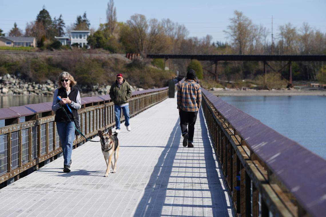 Visitors walk along Little Squalicum Pier on April 4, 2025, in Bellingham, Wash., after it opened to the public for the first time since it was built in 1912.