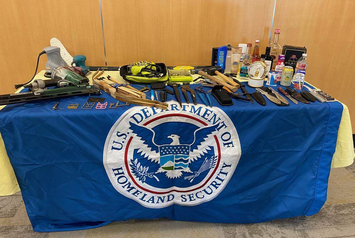 Transportation Security Administration officials display a table of items given up by passengers at Bellingham International Airport on Thursday, June 30.
