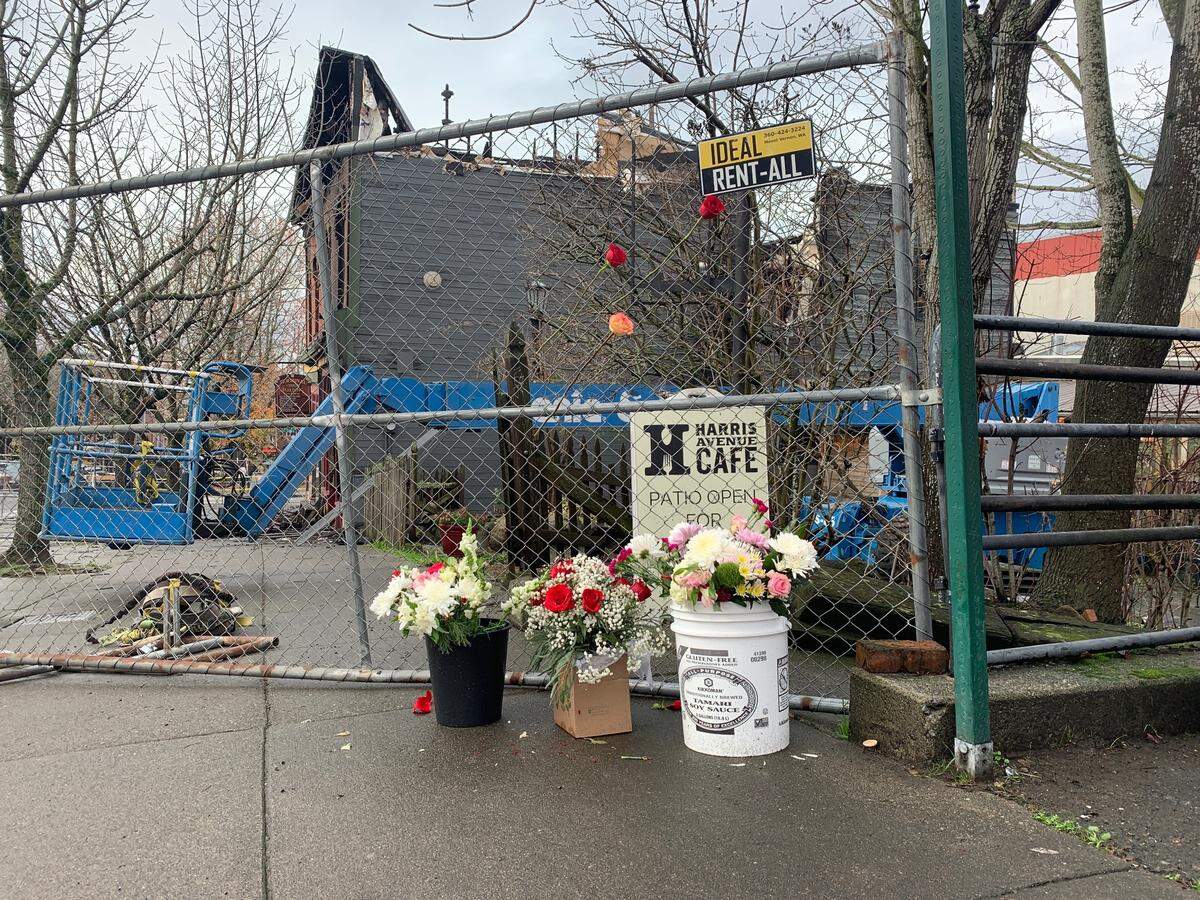 A makeshift memorial began to form on Tuesday, Dec. 19, 2023, outside of the historic Fairhaven Terminal Building that was destroyed by a fire on Sunday, Dec. 17, in Bellingham, Wash.