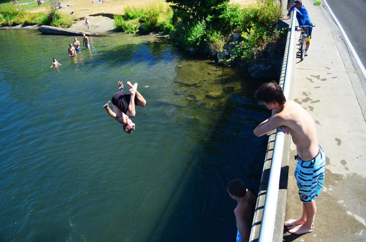 A swimmer flips off the bridge near Bloedel Donovan Park in Bellingham in 2013.