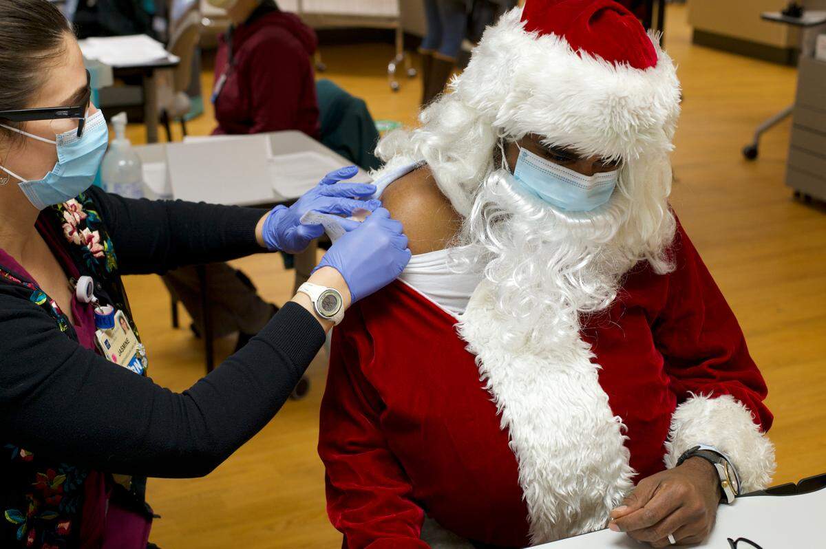 Dr. Sudhakar Karlapudi, chief medical officer for PeaceHealth Northwest, was vaccinated while dressed as Santa Claus at St. Joseph hospital on Monday, Dec. 21, in Bellingham. Dr. Karlapudi spends time in the hospital’s COVID unit so he was eligible to receive the vaccine with other medical workers.