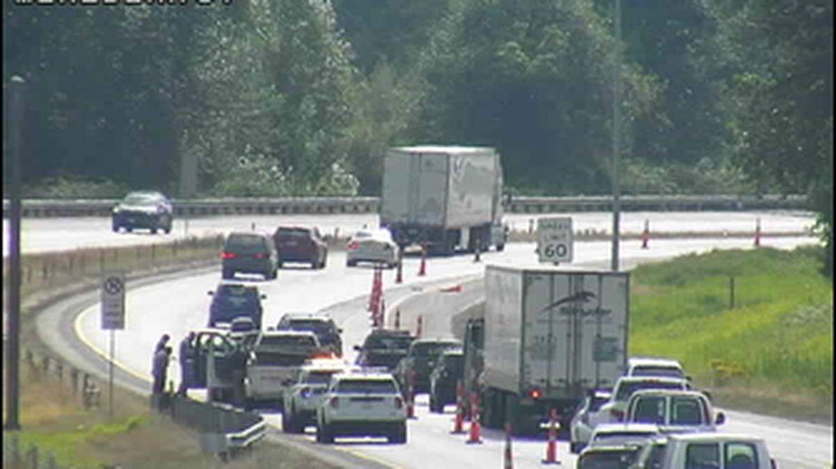 Traffic is backed up south of Meridian Street on I-5 following a collision that blocks the left lane.