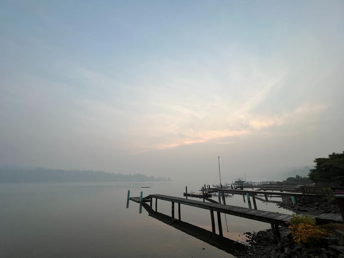 Morning fog and wildfire smoke obscure Stewart Mountain at sunrise on the northeast shore of Lake Whatcom as seen from the beach near Cable Street and Lake Whatcom Boulevard in the Geneva neighborhood outside Bellingham on Wednesday, Oct. 19.