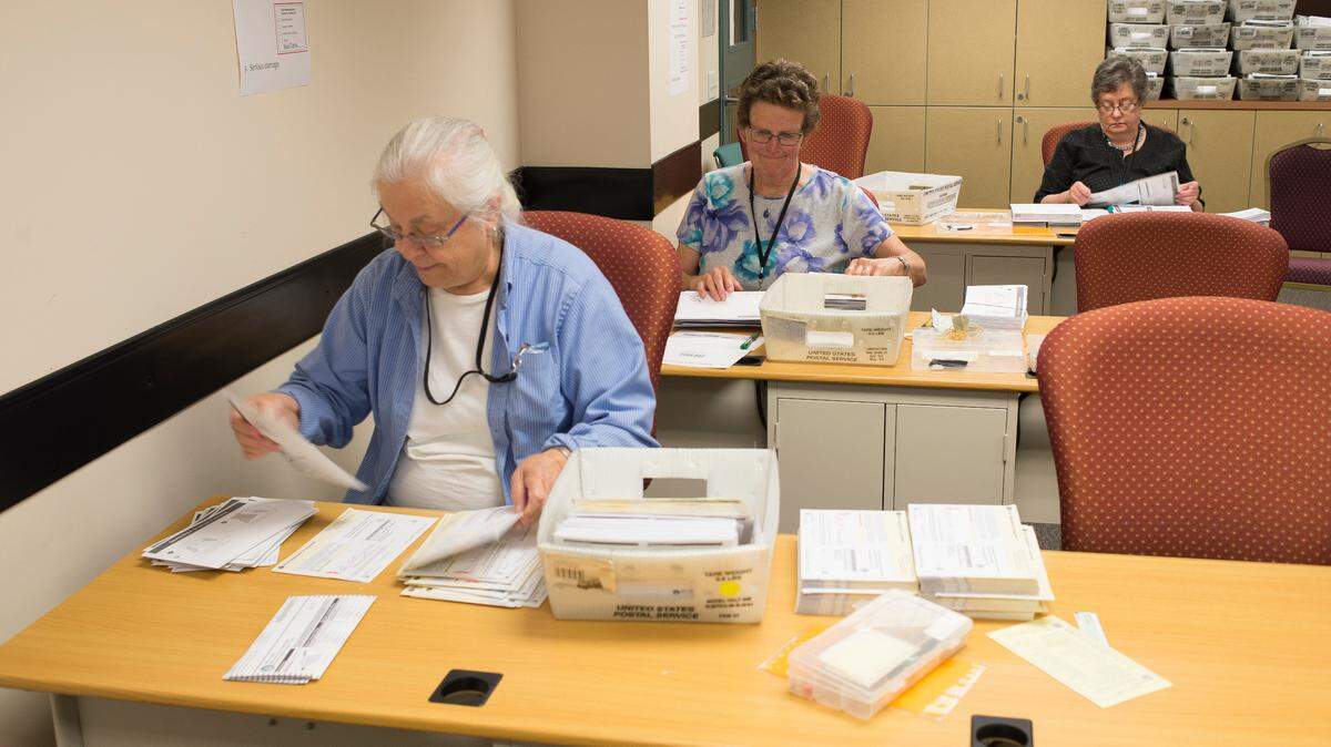 Temporary election workers sort ballots at the Whatcom County Courthouse on Tuesday in Bellingham.