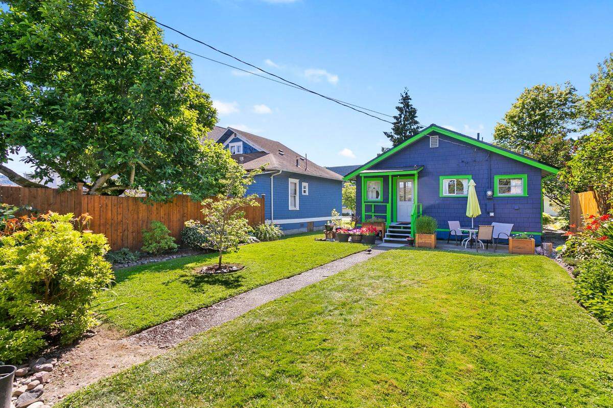 This Seahawk decorated home is for sale now by Molly Visser through John L. Scott in Bellingham and features a large lawn with a patio.