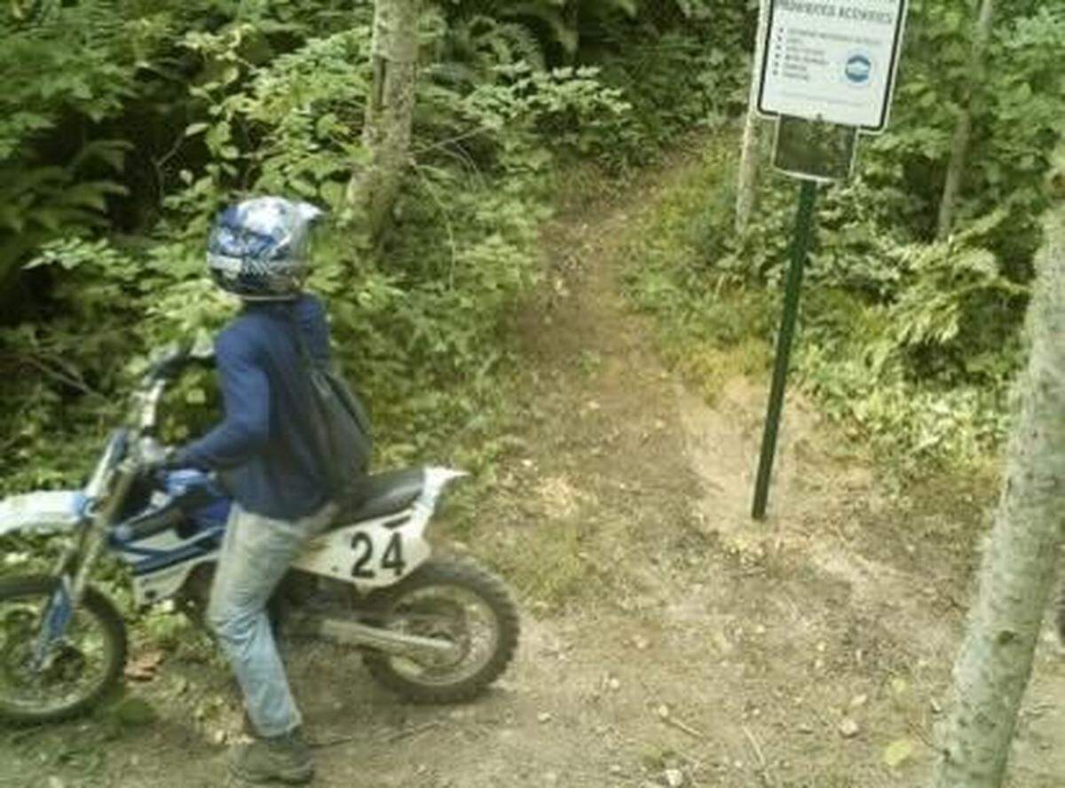 A trail camera photographed a dirt bike rider using a hiking trail in the Lake Whatcom watershed. Such activity is illegal.