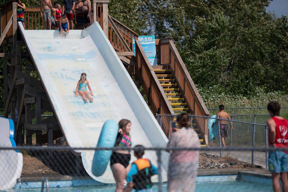 A child slides down a waterslide on opening day at Birch Bay Waterslides on Wednesday, June 30, 2021, in Birch Bay, Wash.
