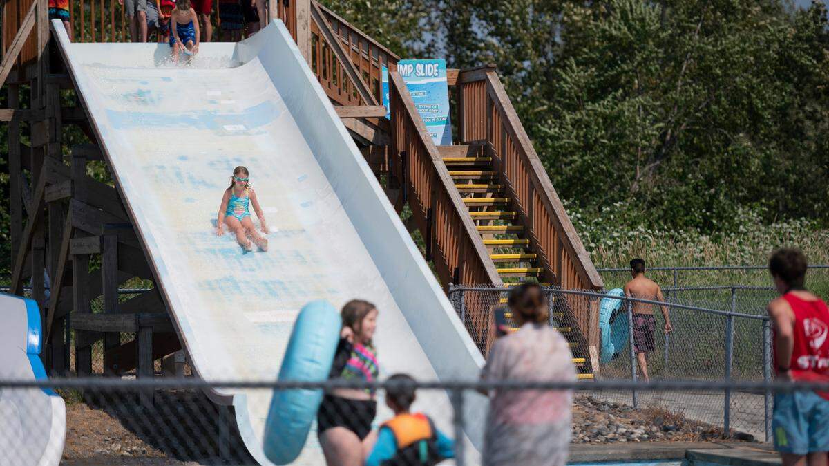 A child slides down a waterslide on opening day at Birch Bay Waterslides on Wednesday, June 30, 2021, in Birch Bay, Wash.