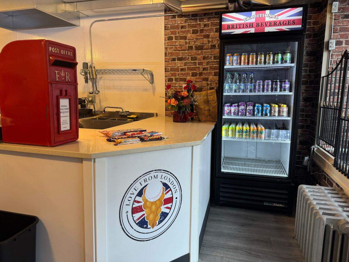 The front counter and fridge of imported beverages from England.