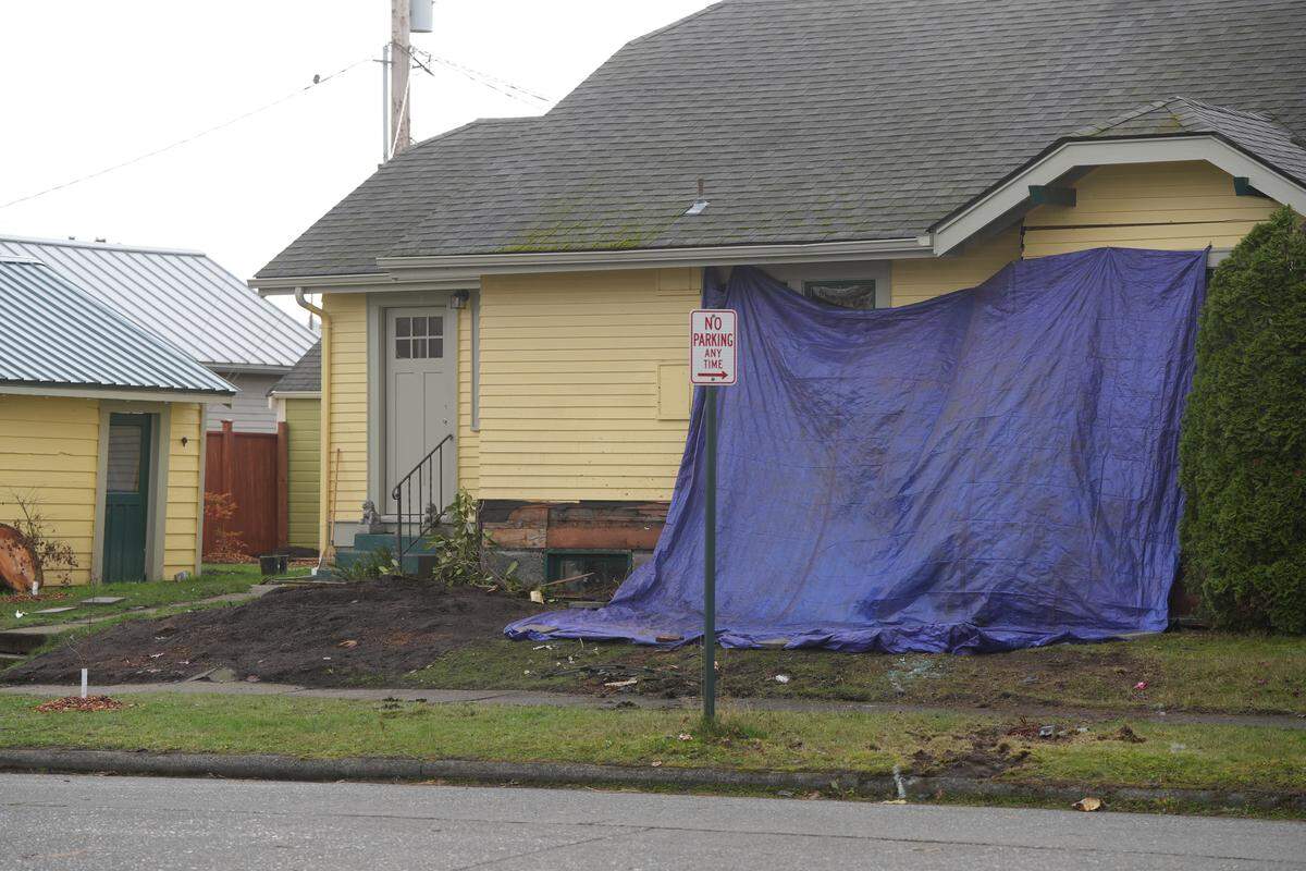 A home on Elm Street sustained significant damage after a car crashed into it on November 21, 2025, in Bellingham, Wash. The driver of the vehicle did not survive injuries suffered in the collision.