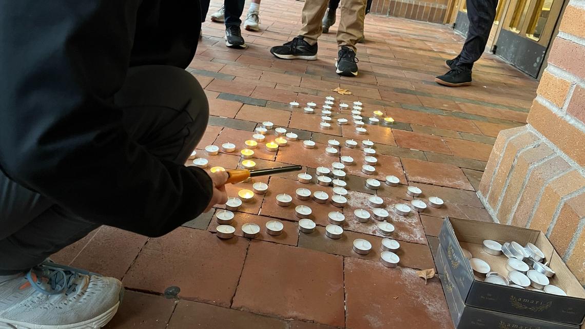 A participant in a prayer service for the victims of terror in Israel lights a candle in the shape of a star of David in Red Square at Western Washington University on Monday. The service was sponsored by the Chabad Temple near campus.