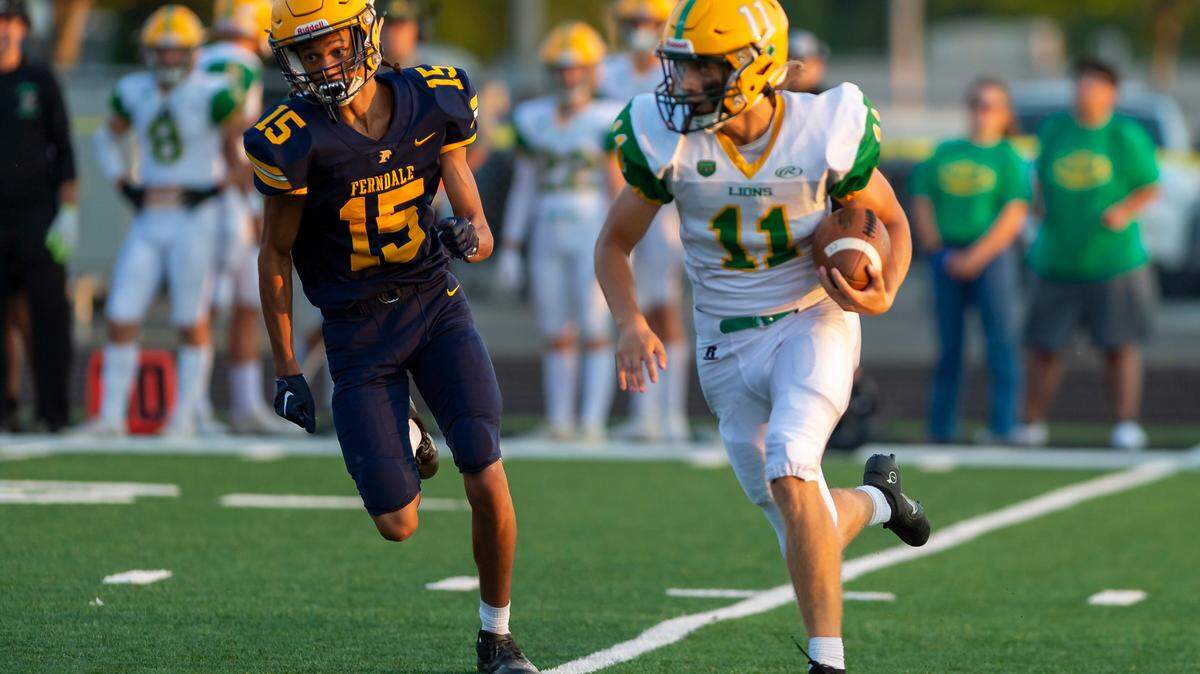 Ferndale defensive back Kevin Woods (15), left, chases down Lynden kicker Tory Petz (11) after he faked a punt and ran for a touchdown during the first quarter on Friday evening, Sept. 2, at Blaine High School. Woods touchdown and the resulting extra point gave Lynden their first score as they went on to defeat Ferndale 24 to 7 in their season opener.