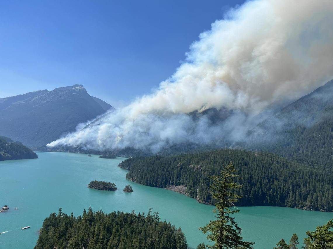 Smoke from the Sourdough Fire rises above Diablo Lake in western Whatcom County on Friday, Aug. 4, 2023.