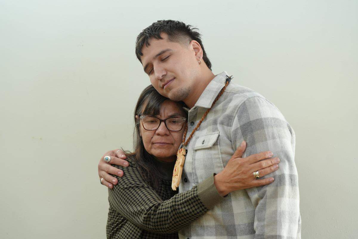 Northwest Indian College wellness advocate Heather Jefferson shares a congratulatory hug with Free Borsey on Nov. 22 at the college.