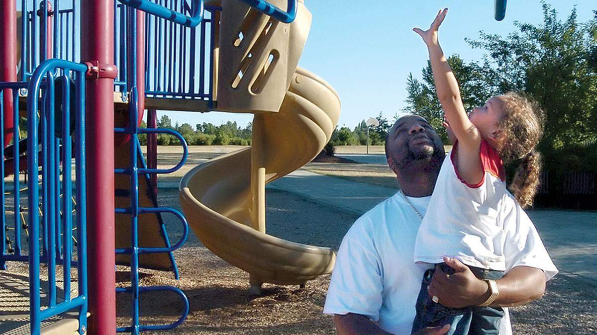 Nathanial Kyle holds up his son, Nathanial, then-3, to reach some climbing bars during a 2007 visit to Birchwood Park in Bellingham. The park, located north of Squalicum Parkway, features a playground, basketball court, picnic shelter and a play field. The site once was home to a shingle mill. It is expected to have a fully usable bike pump track by late spring or early summer 2023.
