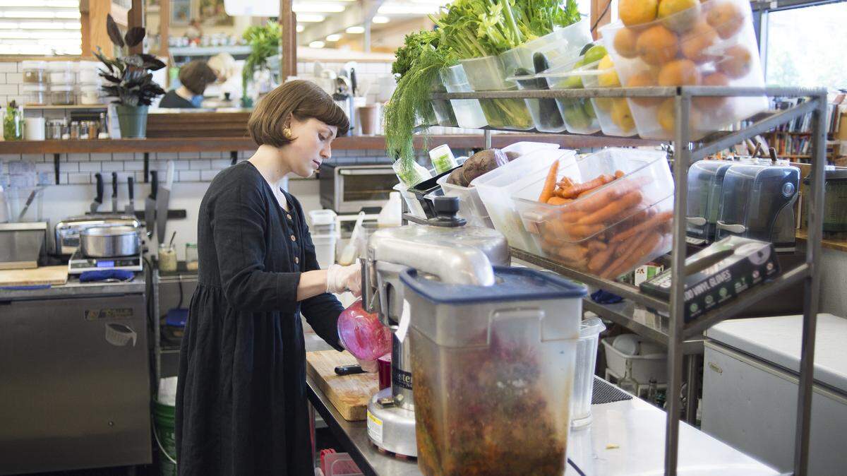 Ashton McNeely makes juice for a customer at Electric Beet Juice Co. on Thursday at the Bellingham Public Market. Terra Organic & Natural Foods, which holds the lease for the building at 1530 Cornwall Ave., is closing and the fate of a number of businesses at the location is unknown.