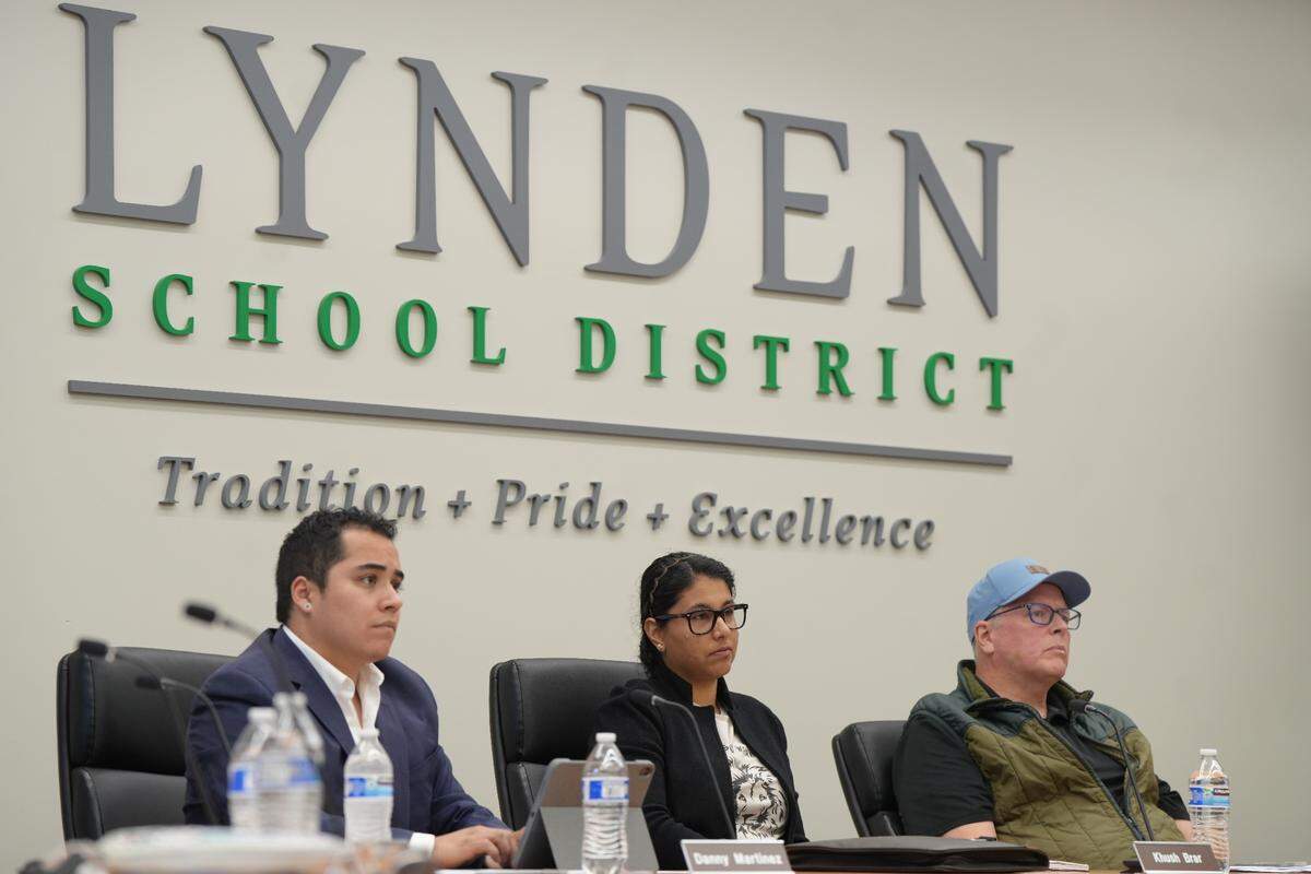 Lynden School District Board members Danny Martinez (left), Khush Brar and Ken Owsley listened at a May 2025 meeting as community members shared public comments opposing the board’s passed resolution regarding concerns over transgender students participating in girls’ sports.