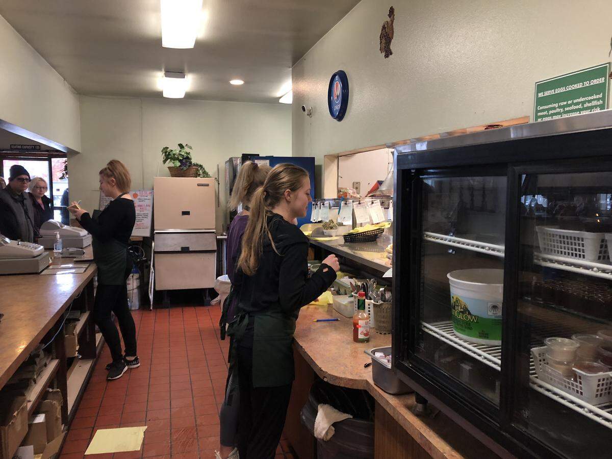 Employees at Lee’s Drive-In fill orders during the lunch hour on Thursday. The longtime Bellingham restaurant will be closing for good on Sunday.