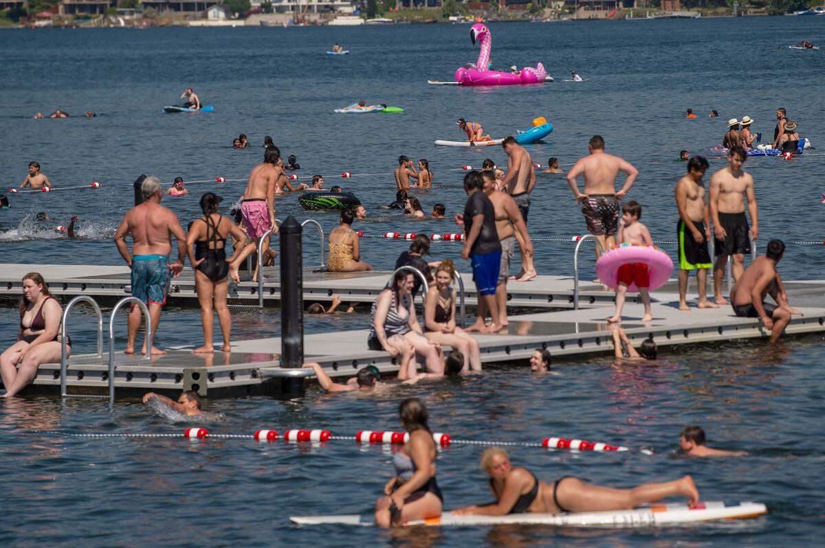 Hundreds pack the new floating H docks waters of Lake Whatcom to combat the record heat at Bloedel Donovan Park on Sunday afternoon June 27, in Bellingham.