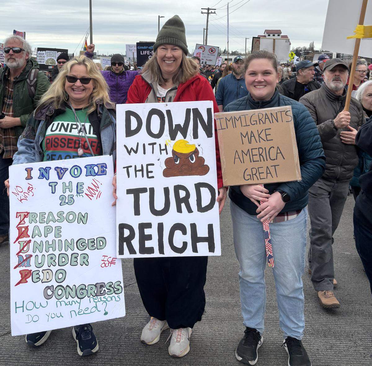 From left, Sarah Jewell, Cassie Scott and Rosalee Farmer at Bellingham’s No Kings rally March 28, 2026.