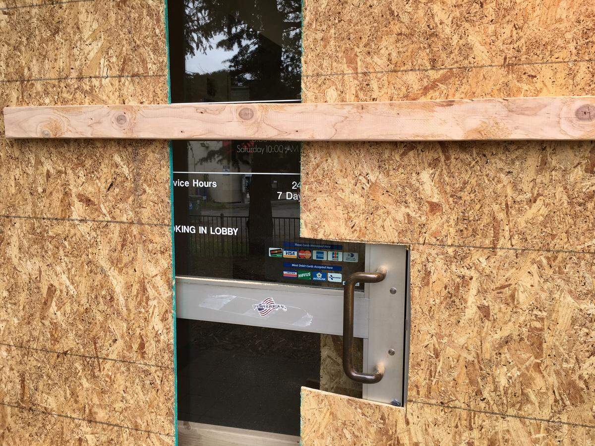 Doors and windows were boarded shut Sunday at the post office's Mount Baker Station in Bellingham.