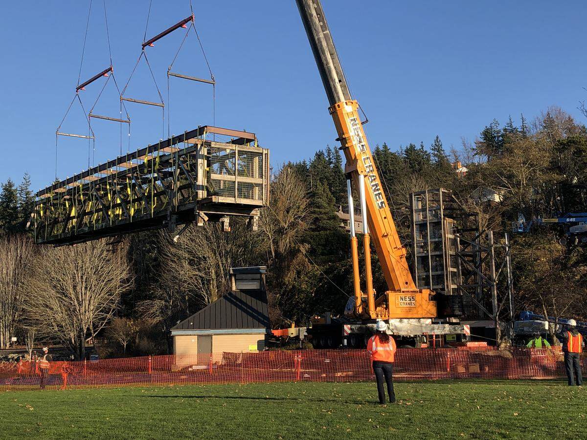 A construction crew aided by a large crane removed the first portion of Boulevard Park’s 40-year-old trestle bridge on the north side of the park in Bellingham Thursday, Nov. 22.