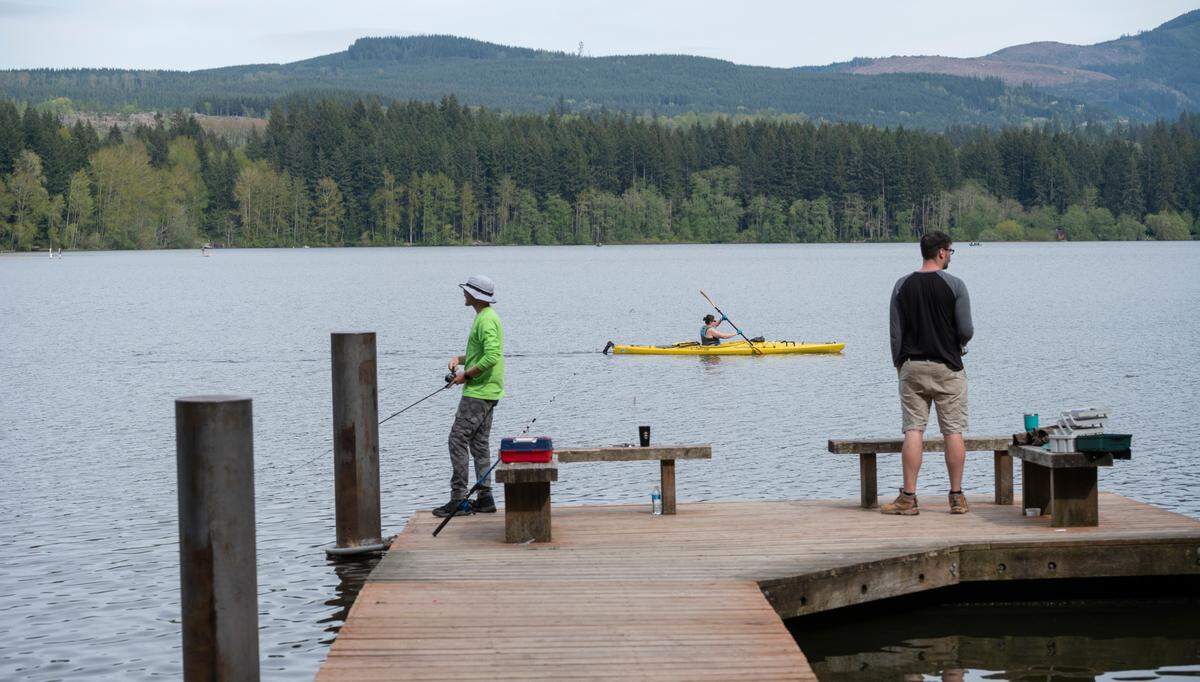 People fish at Lake Padden on April 29, 2021, in Bellingham, Wash.