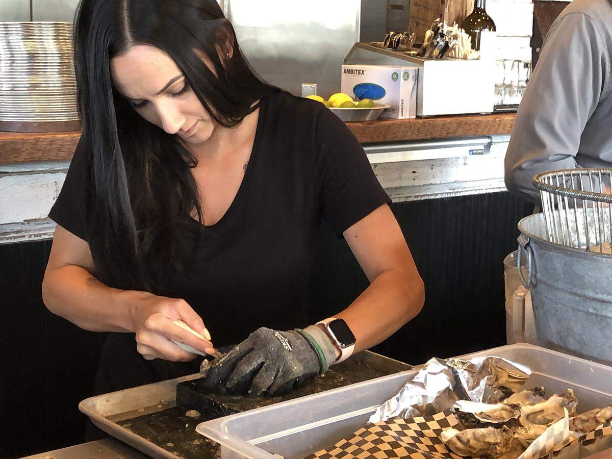 Employee Gabbi Lord prepares oysters Thursday at Drayton Harbor Oyster Company. The restaurant, along with Kaisacole Seafood, a division of Barlean’s Fishery, moved into a new building in downtown Blaine last month.