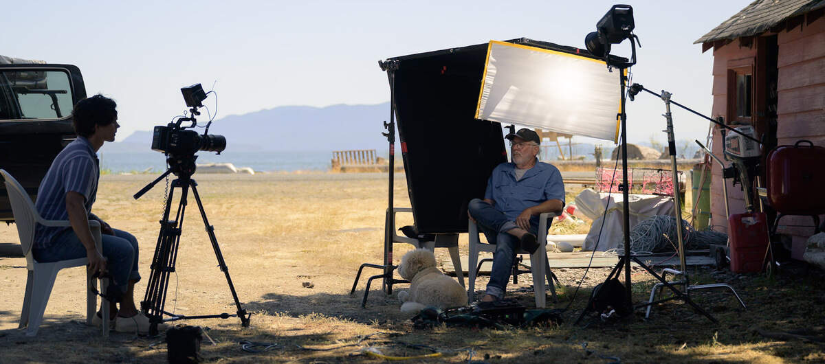 Samuel Wolfe films an interview with Riley Starks, executive director for the Salish Center for Sustainable Fishing Methods at Kinley residence on Lummi Island in Washington.