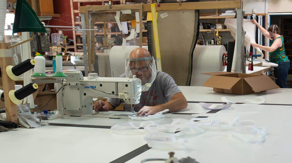 Greg Keeler sews Humanity Shields at the Oyster Creek Canvas shop on Tuesday, July 21, in Bellingham. The company wasn’t planning to make products to slow the spread of COVID-19 into the summer, but the demand is so strong they are getting ready to hire more workers.