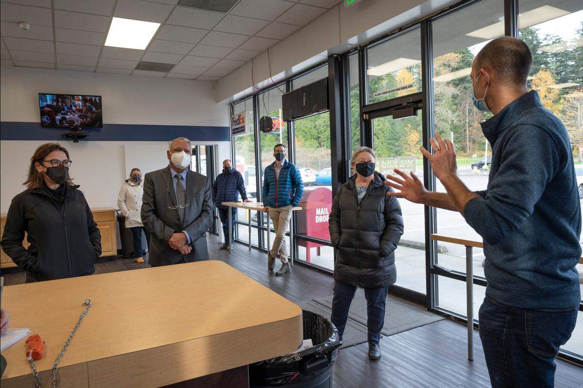 U.S. District 1 Rep. Suzan DelBene, left, Whatcom County Executive Satpal Sidhu, Blaine Mayor Bonnie Onyon and other local leaders visit with Brant Baron, owner of MailBoxes International, following the opening of the U.S.-Canadian border on Monday, Nov. 8, in Blaine.