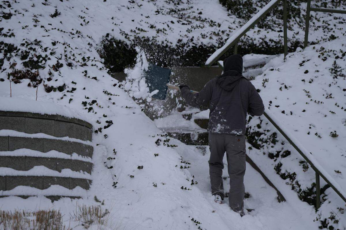 A resident shovels snow off his stairs on N State Street on Wednesday, January 17, 2024, in Bellingham, Wash.