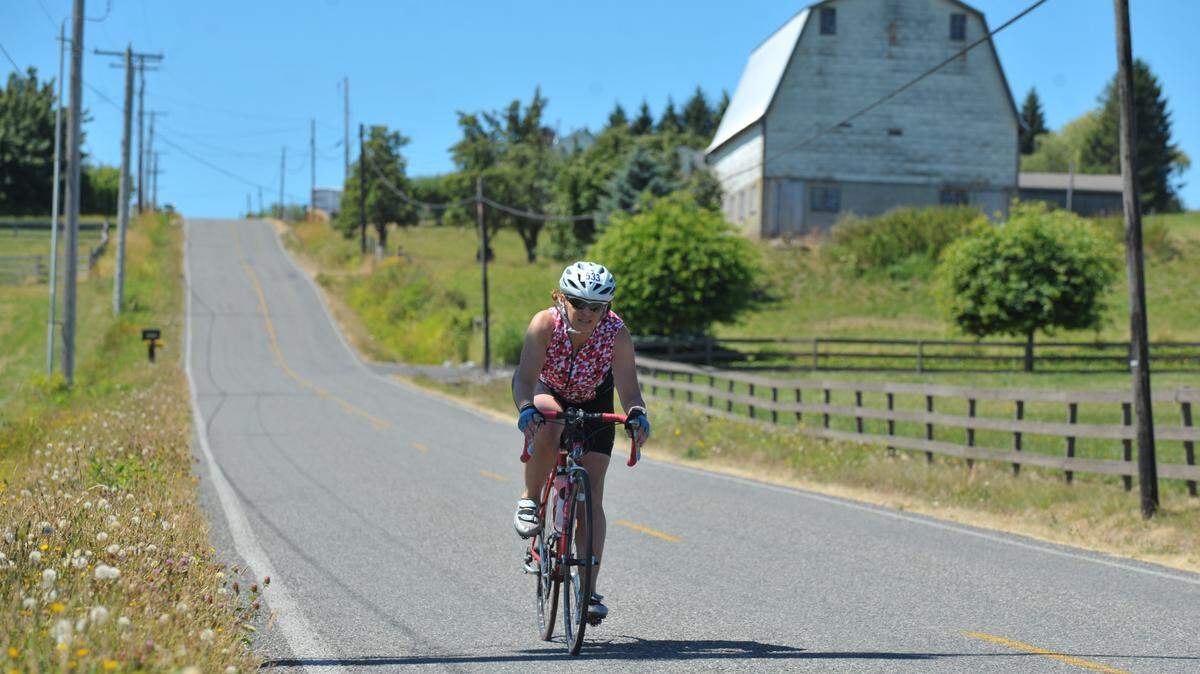 A cyclist heads down Douglas Road near Ferndale, Washington during the 2013 Tour de Whatcom.
