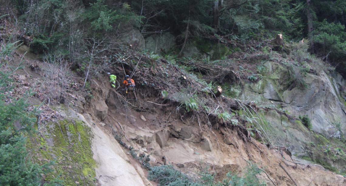 Workers clear out trees and other debris from the Interstate 5 landslide that occurred on March 19, 2026.