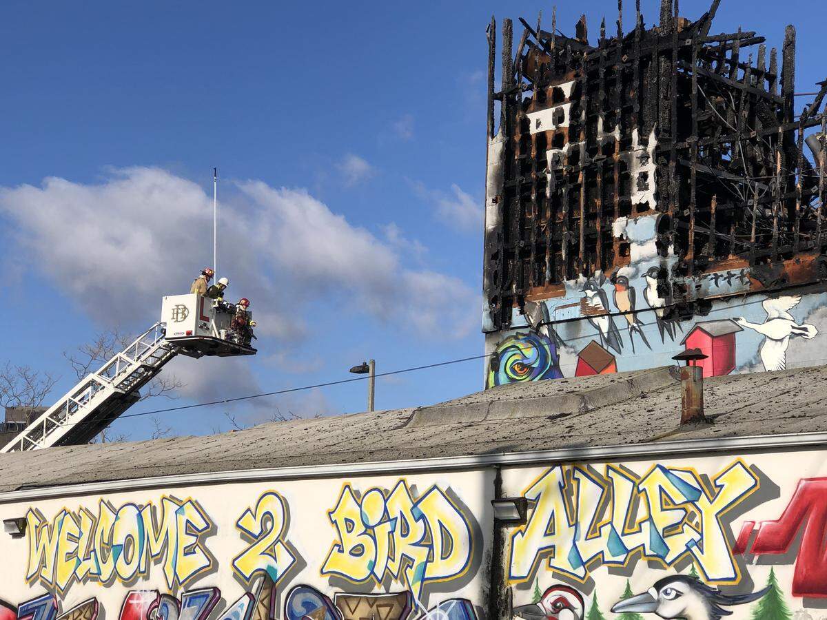 Firefighters return Wednesday to Hohl Seed & Feed to douse smoldering rubble at the downtown business that burned Monday in Bellingham.
