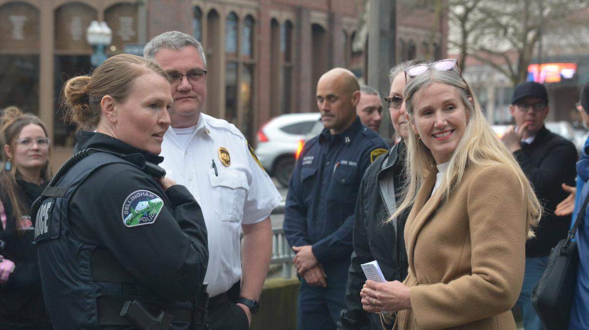 Bellingham Mayor Kim Lund, right, chats with city officials during an event Tuesday, Feb. 20, 2024, where she announced the opening of a new substation for first responders and other measures aimed at addressing the opioid crisis downtown. The substation is in a storefront along the Commercial Street parking garage between Holly and Magnolia streets. Police Chief Rebecca Mertzig is at left and Fire Chief Bill Hewett is second from left.