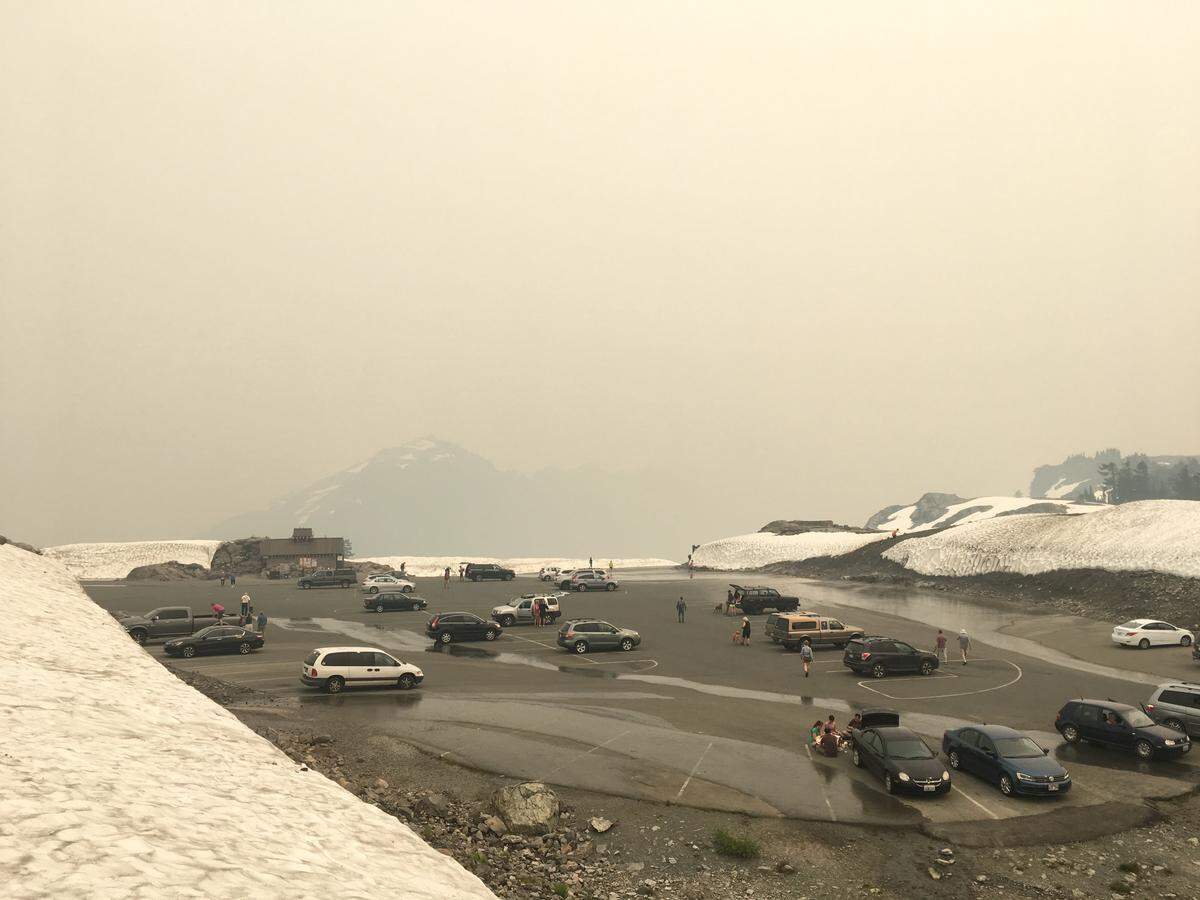 Smoke from wildfires around British Columbia and the West obscures a normally scenic view of Mount Shuksan and the Cascades range from the parking lot at Artist Point in Whatcom Country in August 2018.
