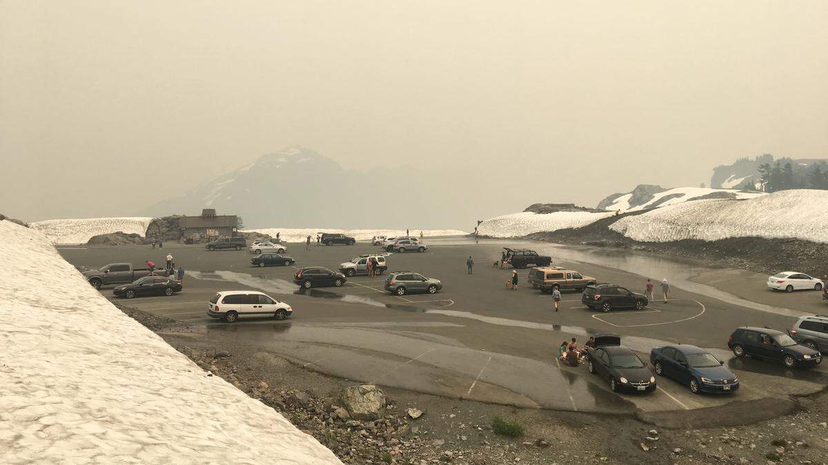 Smoke from wildfires around British Columbia and the West obscures a normally scenic view of Mount Shuksan and the Cascades range from the parking lot at Artist Point in Whatcom Country WA, in August 2018.