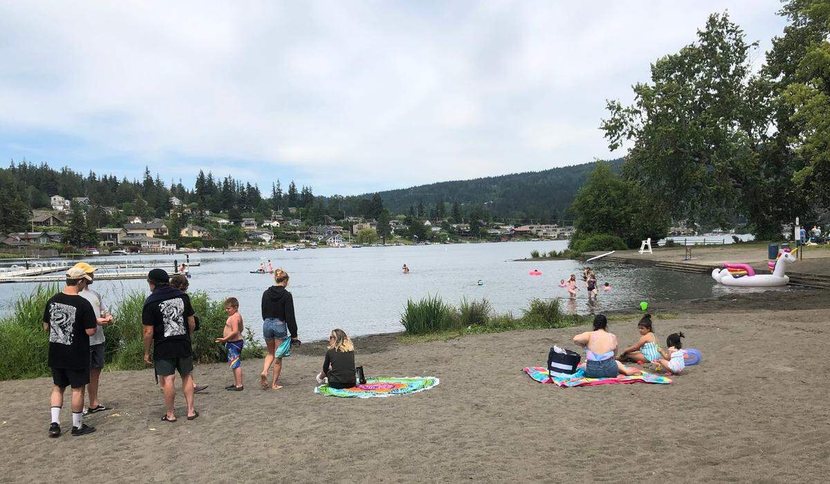 People play in Lake Whatcom and relax on the beach at Bloedel Donovan Park Saturday, July 2, in Bellingham. Temperatures above 80 degrees are in the forecast next week for Whatcom County, and there’s a small chance the area could see highs near the triple digits.