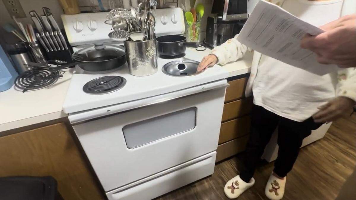 Bellingham resident Maria Alexander points to the non-functioning stove in her apartment during a rental inspection in early 2026. Her property managers later replaced the stove.
