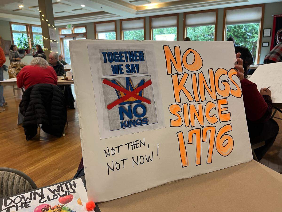 Indivisible Bellingham members made signs for the March 28 rally during an event on March 14, 2026, at the Bellingham Unitarian Fellowship in Bellingham, Wash.