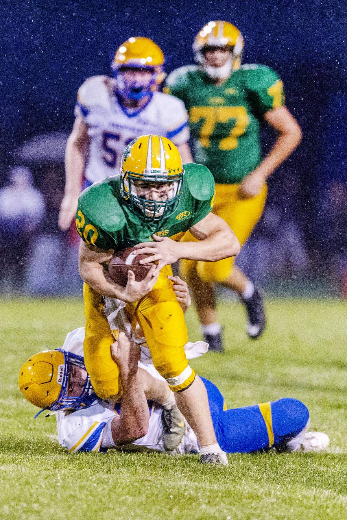 Lynden running back Steven DiLorenzo (20) is tackled by Ferndale linebacker Gader Fox Sept. 7, 2018, at Lynden High School. Hard work after a devastating injury has helped DiLorenzo to record-setting performances, and Lions hope to ride their running back into the state playoffs.