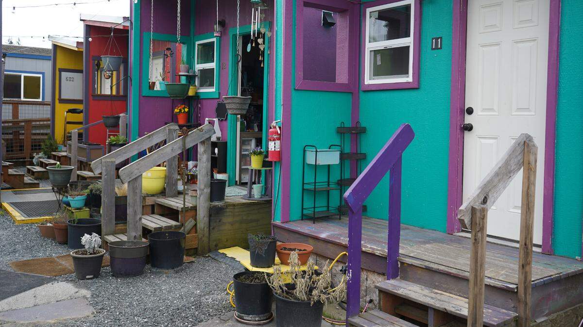 Decorations and plants adorn the outside of some tiny homes at Unity Village on April 20, 2023, in Bellingham, Wash. The nonprofit HomesNOW! opened Unity Village in 2019 as the city’s first tiny home village for homeless individuals.