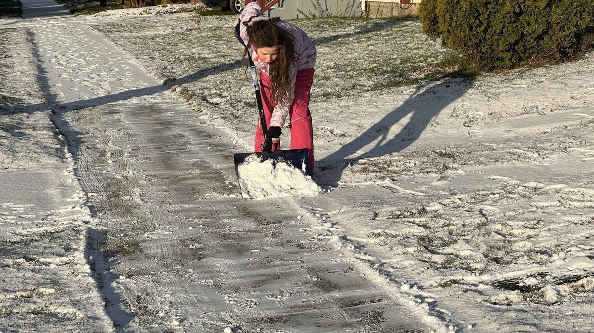 Marley Dawkins, 9, shovels the sidewalk near her home in the Sunnyland neighborhood on Tuesday.