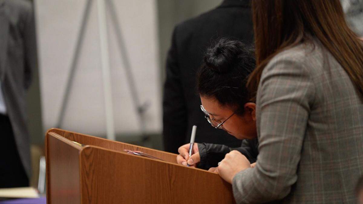 Julio C. Ortiz-Ortiz, 27, signs a document in court on Friday, Dec. 8, 2023, during his first appearance. Ortiz-Ortiz is accused of attempted rape. Bellingham police believe it is likely there are multiple victims.