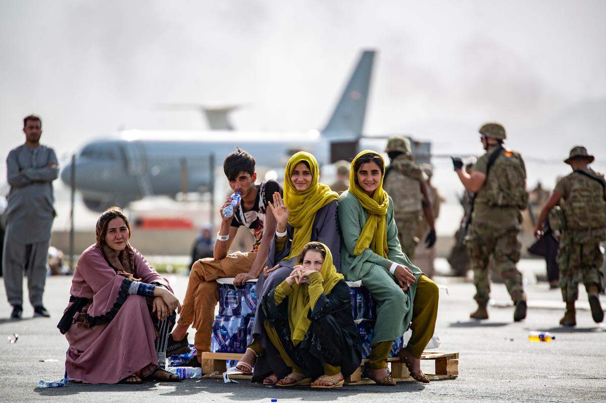 In this image provided by the U.S. Marines, evacuee children wait for the next flight after being manifested at Hamid Karzai International Airport, in Kabul, Afghanistan, Thursday, Aug. 19.