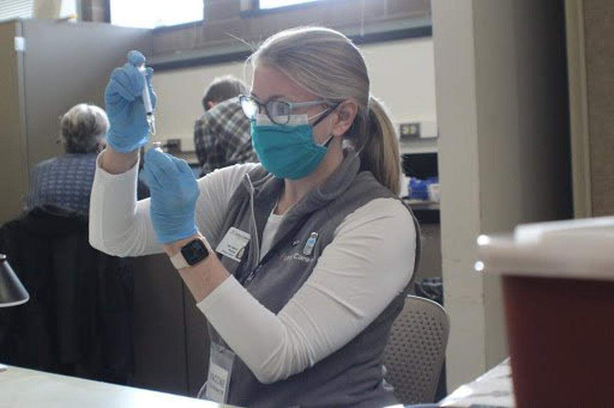 Health care staff from Unity Care NW prepare COVID-19 vaccine at the Community Vaccination Center’s clinic on March 6 at Bellingham Technical College in Bellingham. The next clinic is Saturday, April 10.